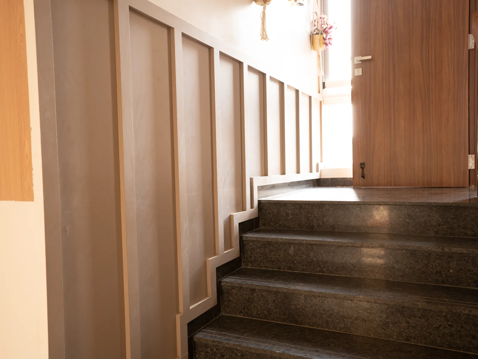 Granite staircase with panelled wall — Amlan's Residence